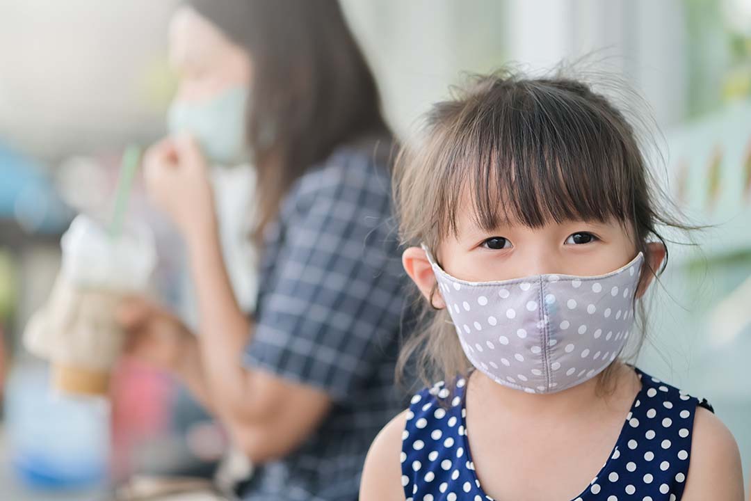 Cloth face mask on little girl