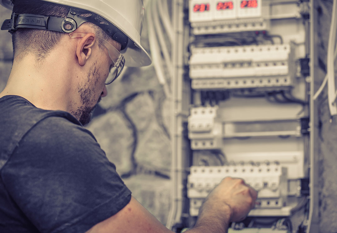 Electrician working on switchboard