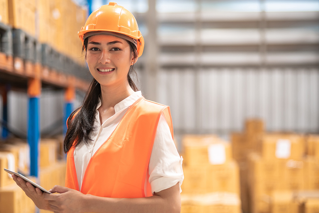 Female holding iPad in warehouse