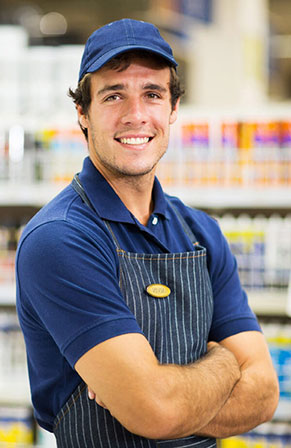 Grocery or hardware store clerk smiling at camera