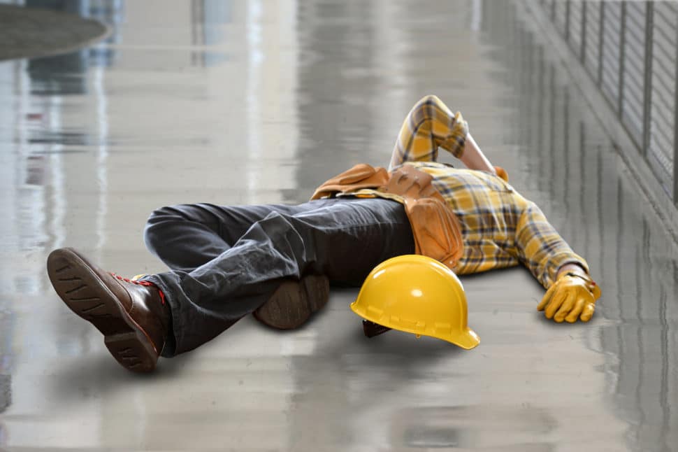 Injured construction worker laying on floor after fall