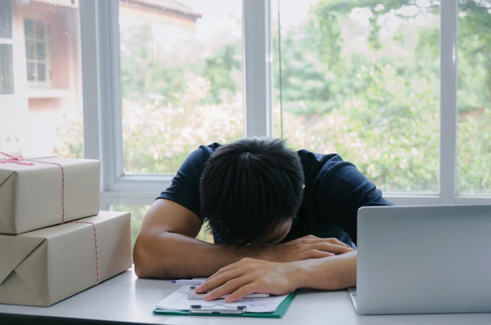 Tired employee laying head on desk