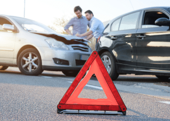 Two men examining a minor car accident