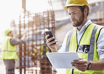 construction worker using phone for online safety training